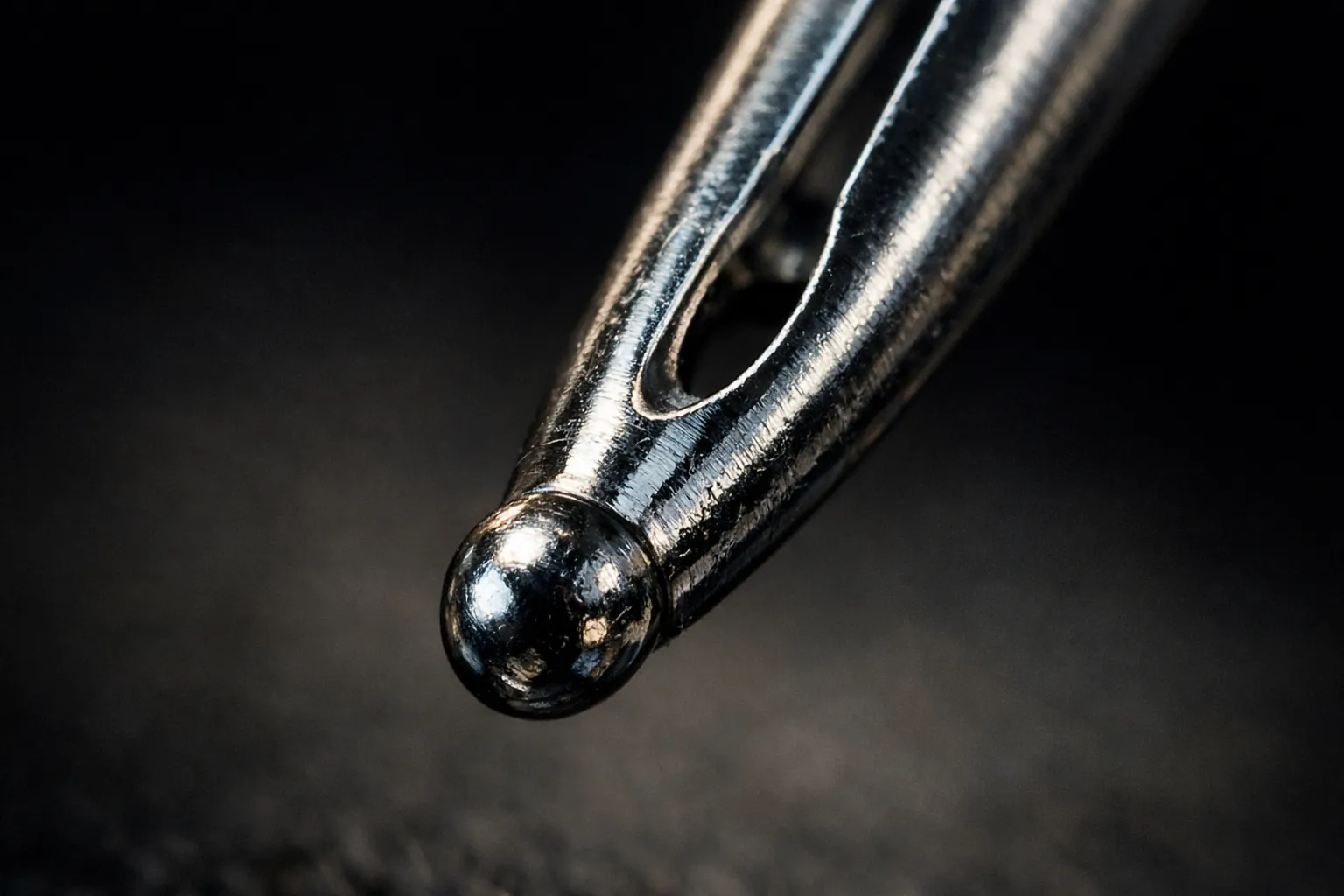 Macro of a sewing machine needle point and eye